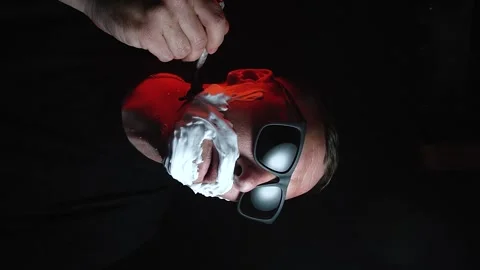 Young man shaving his face with white foam Stock Footage 308538171