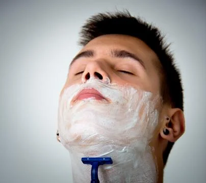 Young man shaving Stock Photos