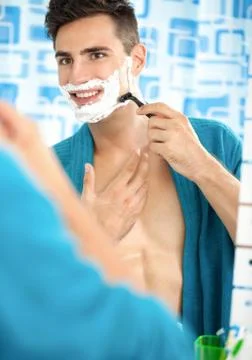 Young man shaving Stock Photos