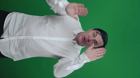 Young man in shirt dancing, having fun on a green background. Stock Footage 148447319