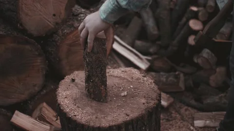 Young man in shirt throw down wood to place new one and continue chopping Video stock 141023537