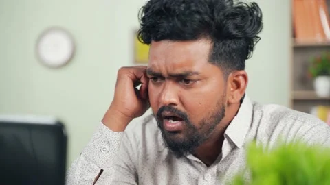 Young man is shocking by reading a bad news in laptop at home Stock Footage 145867115