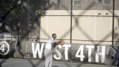 Young man shooting and scoring 3 pointer on West 4th Street basketball court NYC Stock Footage 76348219