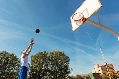 Young man shooting free throws from the foul line Stock Photos