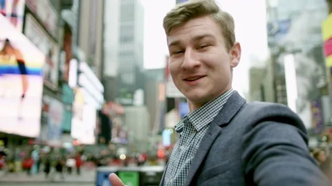 Young man is shooting himself and rotating around on Times Square Stock Footage 79542925