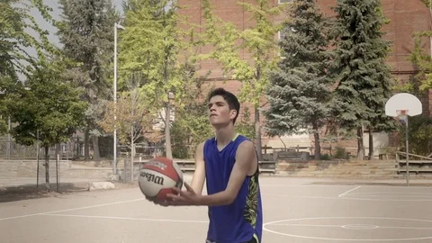 Young man shooting hoops in super slow motion. Stock Footage 82917219