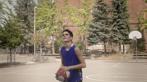 Young man shooting hoops in super slow motion. Stock Footage 82917422