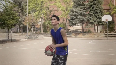 Young man shooting hoops in super slow motion. Stock Footage 82917491