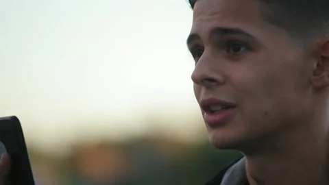 Young man shooting video message for his friend on the street Видео 97409266