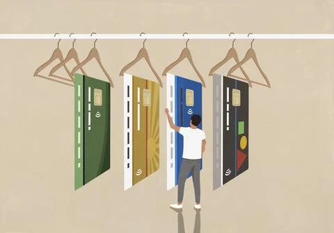 Young man shopping, looking at different credit cards on display hangers Ilustración de archivo