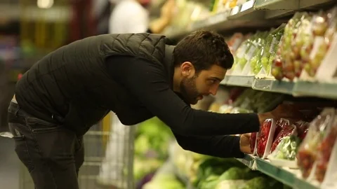 Young Man Shopping at Supermarket Stock Footage