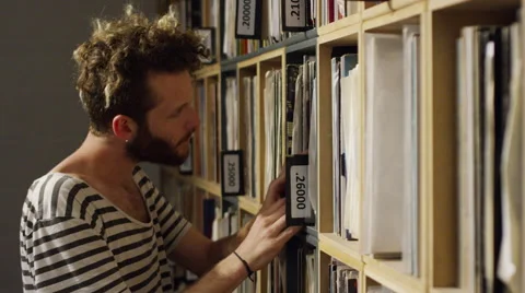 Young man shopping for vinyl records in music store Stock Footage 59763146