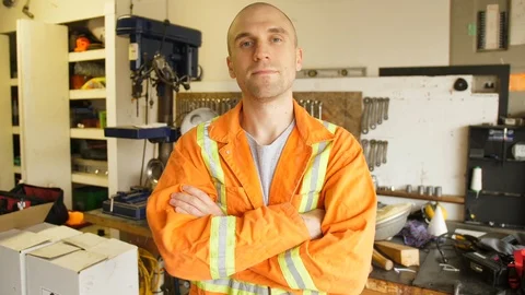 Young Man With Short or No Hair Wearing Safety Coveralls in Mechanics Shop Stock Footage 90799490