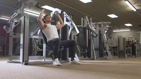 Young Man on Shoulder Press Machine in Gym Stock Footage 85286645