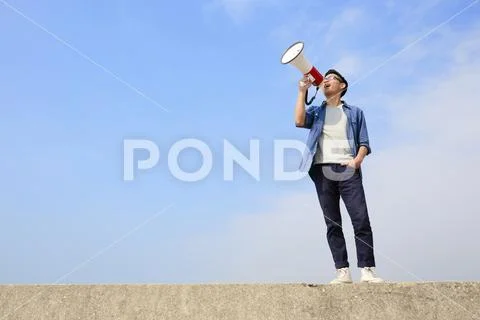 Young man shout megaphone Stock Photos