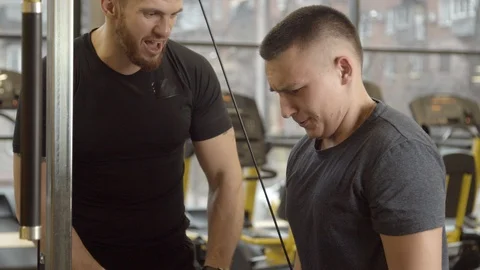 Young man shouted at by instructor while working out in gym Stock Footage 125531748