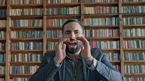 Young Man Shouting In The Library. Vídeos de archivo 140222191