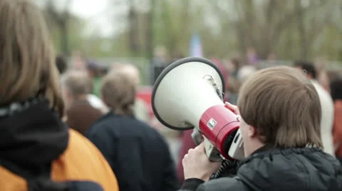 Young man shouting with a megaphone Stock Footage 23119126