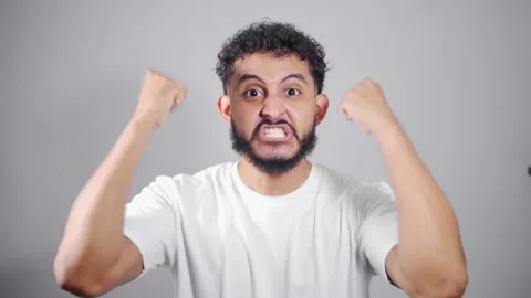 Young man showing different expressions of anger on white background Stock Footage 315051623