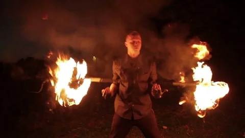 Young man showing a fire show outdoors. Video stock 81572556