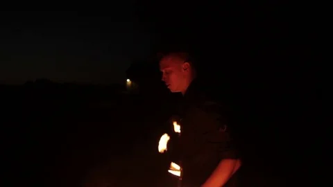 Young man showing a fire show outdoors. Video stock 81574714