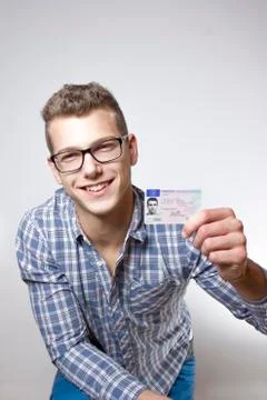 Young man showing off his driver license Stock Photos