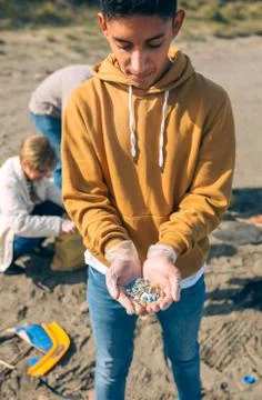 Young man showing microplastics Stock Photos