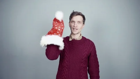 Young man showing a puppet show using a Santa hat Christmas preparation Stock Footage 70263350