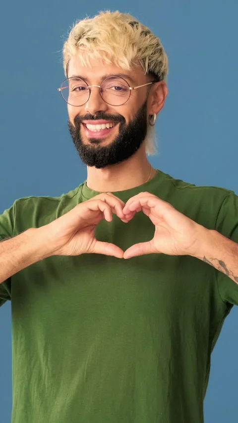 Young man showing representing heart in the shape of fingers gesture isolated on Stock Footage 297205385