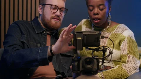 Young Man Showing Setting Up Camera Process to African American Woman Stock Footage 294707776