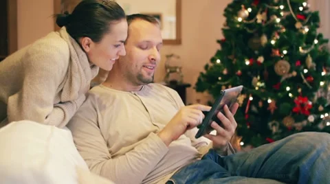 Young man showing something to his girlfriend on tablet computer HD Stock Footage 10608155