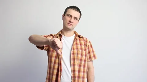 Young man showing a thumb down sign Stock Footage 60407696