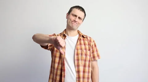 Young man showing a thumb down sign Stock Footage 60407698