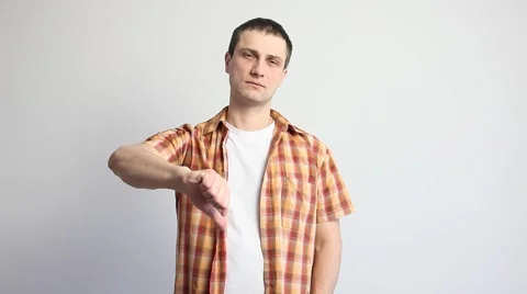 Young man showing a thumb down sign Stock Footage 60407706