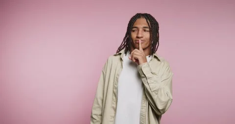 Young man shows different expressions in studio with pink background in pla.. Video stock 331989729