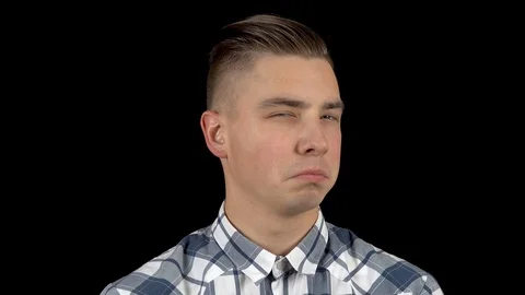 A young man shows emotion a contemptuous look on his face. A man with a scornful Stock Footage 122253567