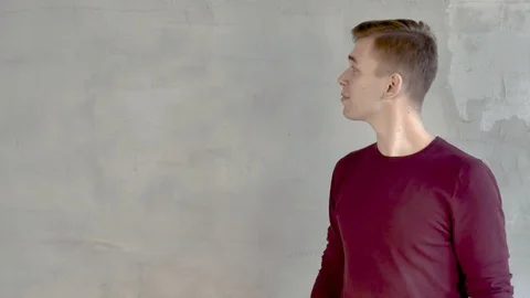 Young man shows a presentation points his hand to 4 positions on the left Video stock 120387068