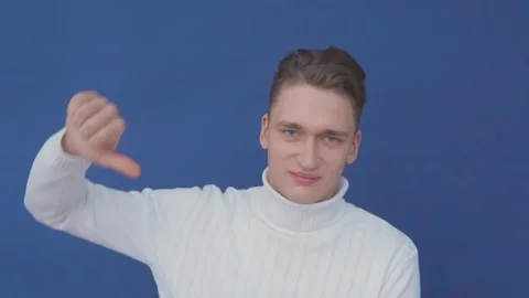 Young man shows thumb down. Close-up. Stock Footage 145064991