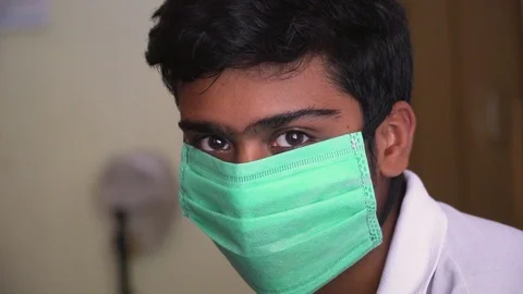 Young man sick looking dull with mask corona virus bacteria air pollution Video stock 127678830