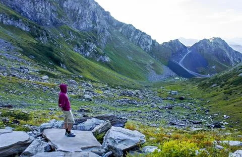 Young man from side looking at the green mountain valley Aibga ridge Stock Photos