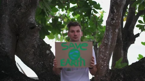 A young man with a sign "Save the Earth" Stock Footage 146651808