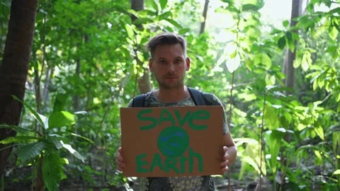 A young man with a sign "Save the Earth" Stock Footage 146652222