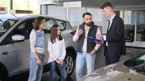 Young man signed a contract of buying family car 스톡 동영상 76377661