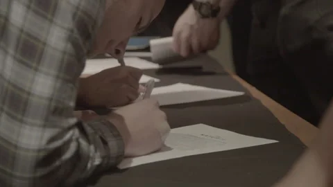 Young Man Signing Registration Document at Seminar Table Stock Footage 342566253