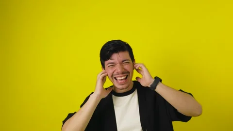 Young man singing and dancing while listening to music with wireless headph.. Stock Footage 311191617