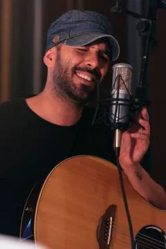 Young man singing in direct. Stock Photos