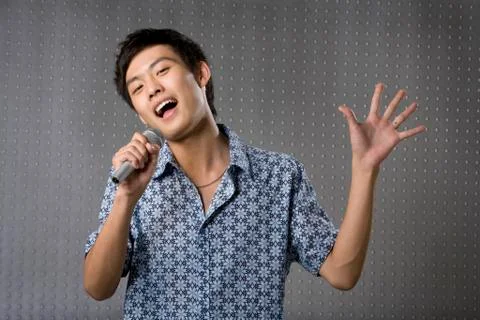 Young man singing karaoke Stock Photos