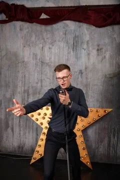 Young man singing with microphone Stock Photos