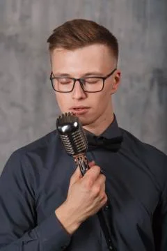 Young man singing with microphone Stock Photos
