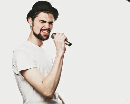 Young man singing with a microphone Stock Photos